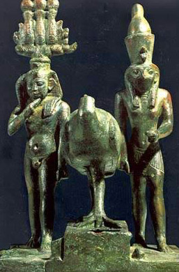A bronze group with, on the left, the Child Horus wearing the Atef Crown, while on the right, Horus as king, wearing the Double Crown