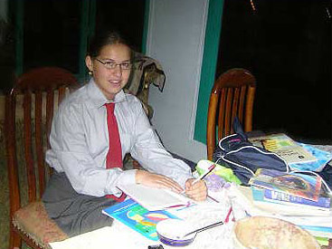 Dressed for school and doing homework