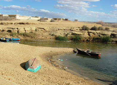 Fishing boats dot the  shoreline of Lake Qarun